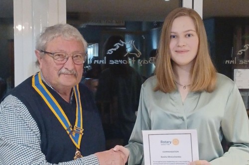 Hereford City Rotary President Kevin presenting the Young Peacemaker Award to Sasha