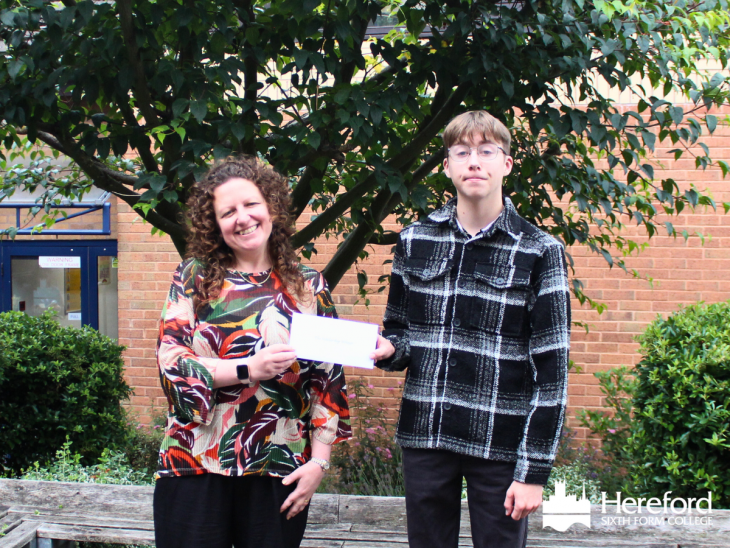 Anthony collects his scholarship from Principal Catherine Brearey