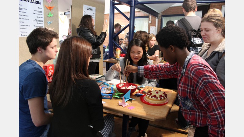 students practice using chop sticks and get a taste of flour-free Chinese cake on the Mandarin stand.